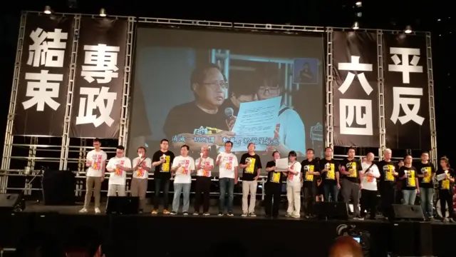 2017年6月4日，香港维多利亚公园举办六四烛光晚会，萤幕上是何俊仁及邹幸彤，舞台两旁写有“平反六四”、“结束专政”字眼。