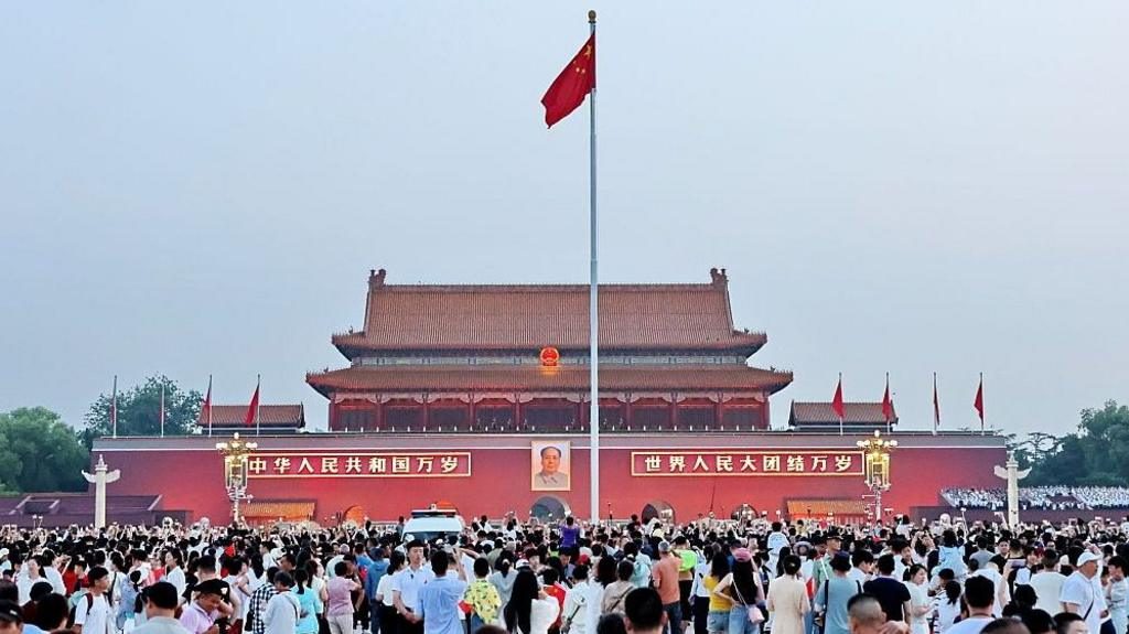 北京天安门城楼前的人群和国旗(资料照片)